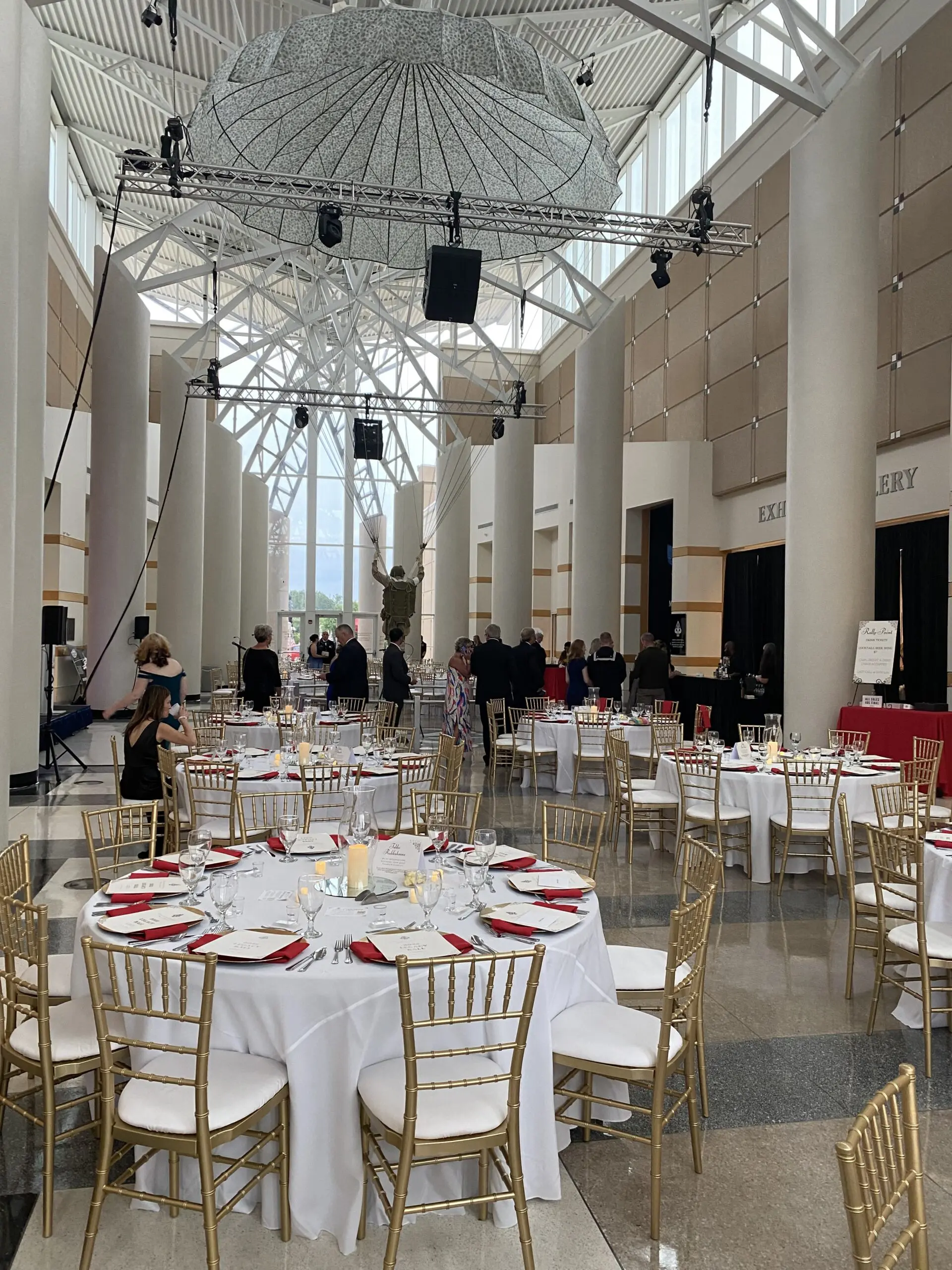 Lobby prepared for a formal dinner beneath the suspended parachute