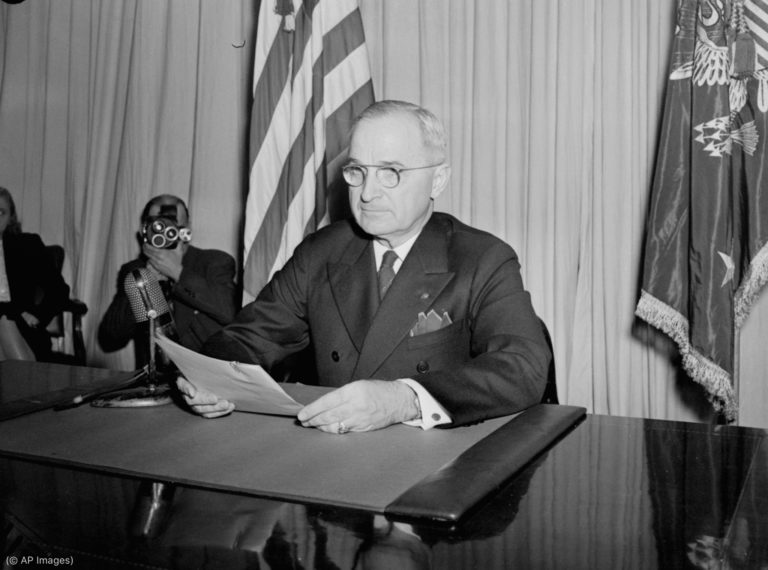 President Truman sits before a microphone, holding his speech, at the White House, Washington, DC, May 8, 1945, after he had finished reading his announcement to the nation that Allied Armies have won unconditional surrender from the German forces on all fronts. (AP Photo/stf)