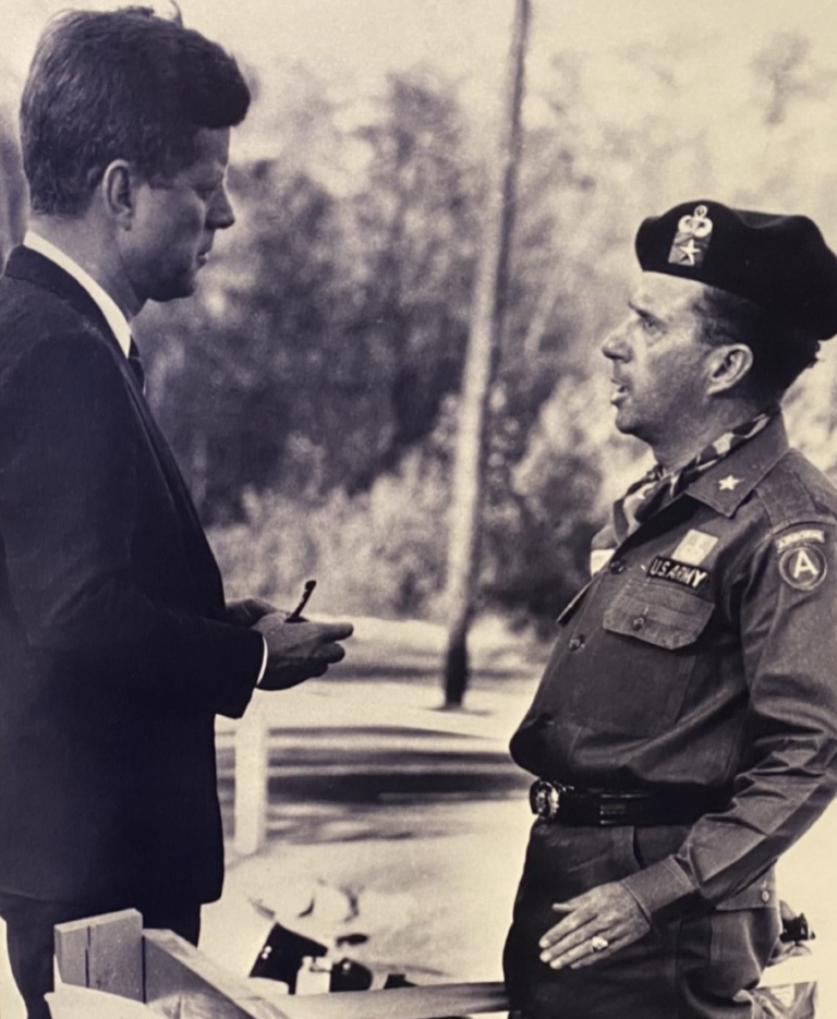 President John F. Kennedy, a major supporter of the Special Forces, talks to Brigadier General William P. Yarborough during combat readiness demonstrations at Fort Bragg, October 1961. 