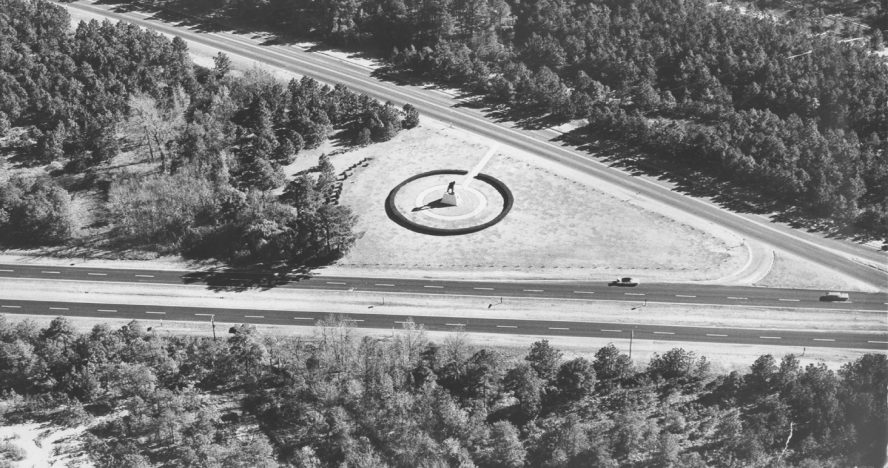 Aerial photograph of the statue's original traffic-circle site at the intersection of Bragg Boulevard and Knox Street