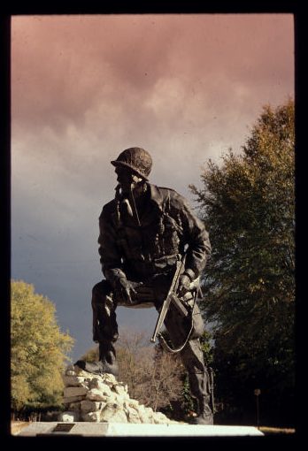 Iron Mike, the Airborne Trooper statue, silhouetted against a stormy sky at Fort Bragg
