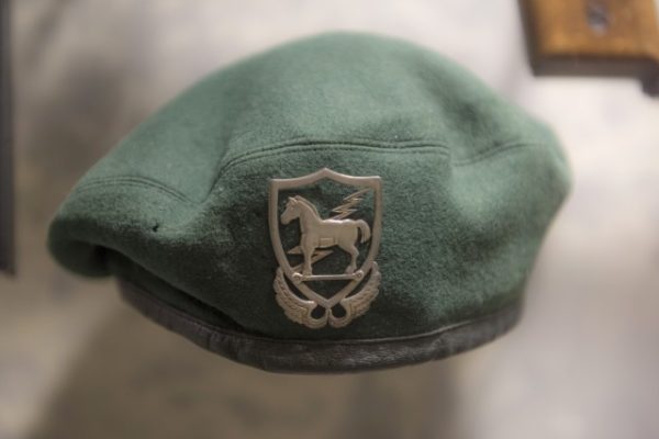 Capt. Roger M Pezzelle designed the Trojan Horse Badge. Pezzelle, an assistant S-3 and “A” team leader serving with the 10th SFG in Bad Toelz, Germany, found inspiration for his design from a French parachutist badge. Pezzelle created the Trojan Horse Badge and engaged a local jeweler Eichmann in crafting it. While Pezzelle worked on the badge, 10th SFG Soldier, Capt. Herbert R. Brucker, commissioned Mutze Muller, a German haberdasher to create Green Berets for 10th SFG. Worn on the beret, the Trojan Horse Badge could be found above an SF Soldier’s left temple. This Green Beret is featured in the ASOM’s collection.